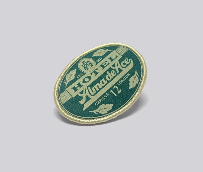 Alma printed clothing badge.